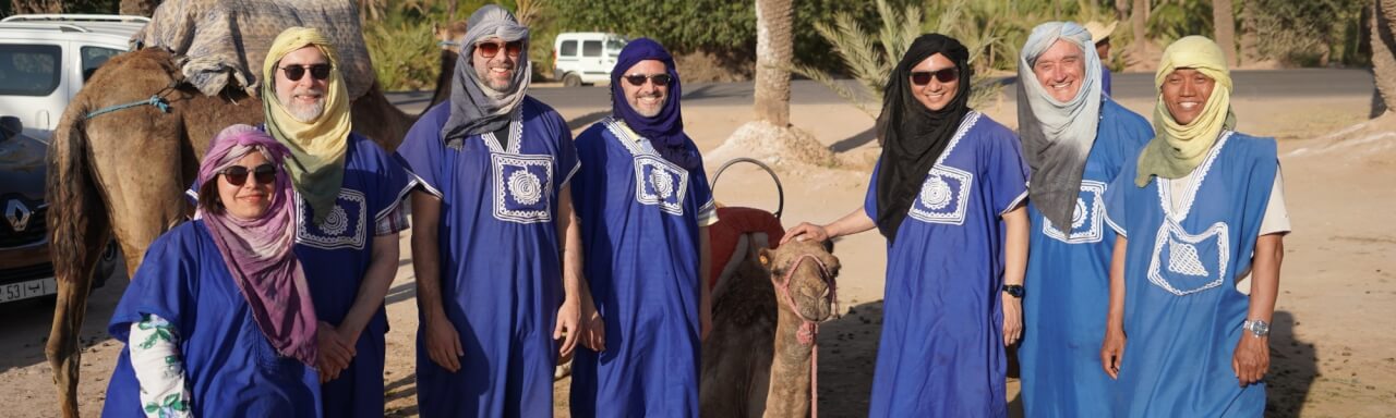 Conference participants preparing for a camel ride